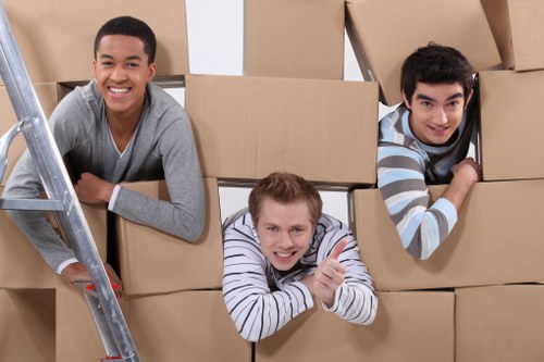 Professional movers transporting office furniture in Lee